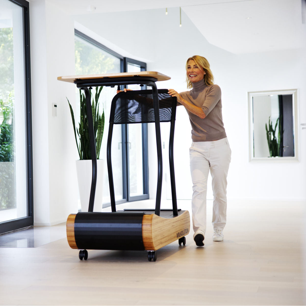 Woman pushes treadmill desk