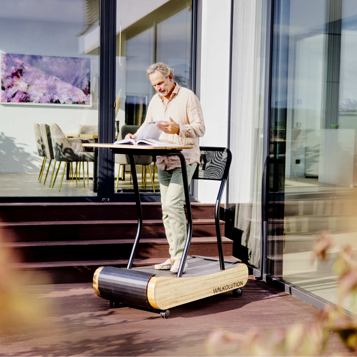 Man using treadmill desk on balcony garden outside WALKOLUTION 